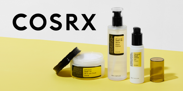 COSRX Advanced Snail skincare set with cream jar, clear essence bottle, and white eye cream bottle on yellow.