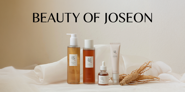 Beauty of Joseon ginseng skincare: pump cleanser, toner, serum, cream, and roots on a soft, neutral fabric.
