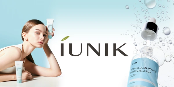 Kobieta z IUNIK Beta-Glucan kremem w tubce i serum nawilżającym w butelce z kroplomierzem, na wodnym tle.