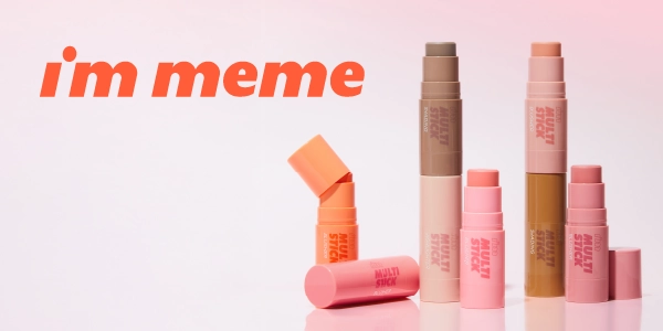 I'm Meme Multi Sticks: assorted blush, contour, and highlight makeup sticks in various colors on a pink gradient.