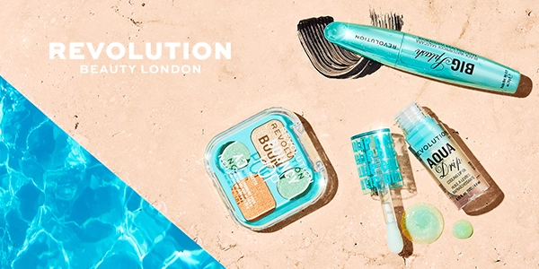 Revolution Beauty London: teal Big Splash mascara, Aqua Drip lip oil, Bouncy Pop compact on textured beige by a blue pool.