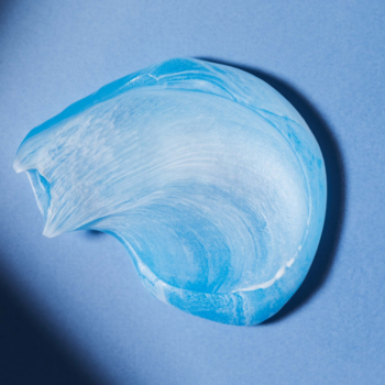 NIVEA MEN Protect & Care żel do golenia z aloesem: zbliżenie na niebiesko-białą, perłową smugę żelu na błękitnym tle.
