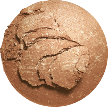 Okrągły, perłowy bronzer Revolution Reloaded w odcieniu Long Weekend, widok z góry, z widocznymi pęknięciami.