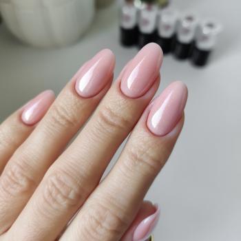 Zbliżenie na dłoń z długimi, migdałowymi paznokciami pomalowanymi lakierem Semilac Smart Extend 804 o wysokim połysku.