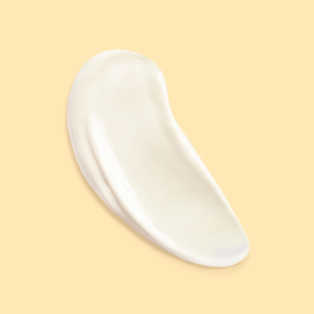 Lierac Sunissime SPF 30, biała smuga mleczka przeciwsłonecznego z transparentnym wykończeniem, na beżowym tle.