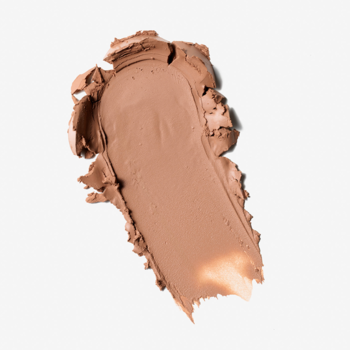 Kremowy bronzer w sztyfcie Everybody London Light. Rozmazana jasnobrązowa smuga na białym tle, widoczna tekstura.
