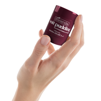 Dłoń trzyma małe, ciemnoczerwone opakowanie Bielenda Soft Pudding Very Cherry, maseczki do ust 3w1.
