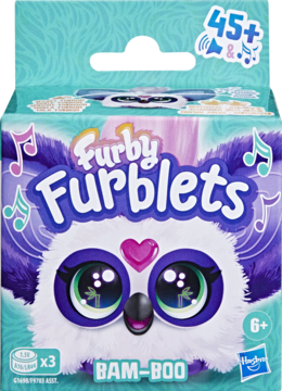 Opakowanie Furby Furblets "BAM-BOO". Fioletowo-biały puchaty stworek z zielonymi oczami i nutami, widok z przodu.