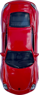 Widok z góry na czerwony sportowy samochodzik zabawka z czarnymi szybami i srebrnymi reflektorami. Idealny dla kolekcjonerów autek.