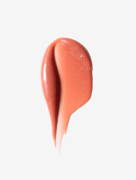 Zbliżenie na połyskujący, brzoskwiniowy swatch tintu do ust Peach Bliss z witaminą E, na jasnym tle.