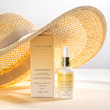 Sensum Mare Algodrops Satin SPF 50+ emulsja przeciwsłoneczna w białej butelce, pudełko i słomkowy kapelusz.