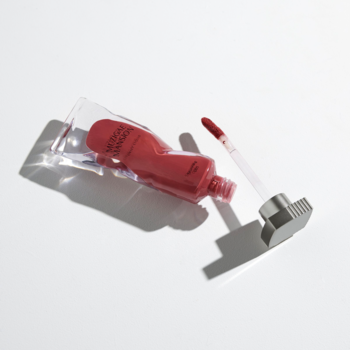 Czerwony tint Muzigae Mansion Stunning, otwarta tubka z aplikatorem na białym tle, widok z góry.