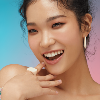 Uśmiechnięta kobieta z makijażem oka Kaja Beauty Bento Velvet Dream w ciepłych odcieniach brzoskwini i różu.