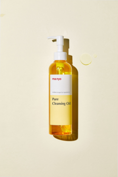 Manyo Pure Cleansing Oil, bursztynowy olejek w butelce z pompką, widok z przodu na żółtym tle z kroplami.