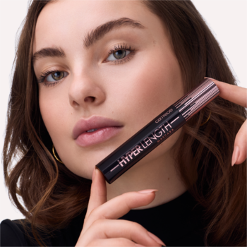 Kobieta prezentuje tusz L'Oréal Paris Hyper Length, czarne opakowanie z różowym złotem, widok z przodu.
