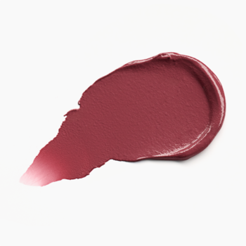 Zbliżenie na kremowy swatch olejkowego balsamu do ust Catrice 030 Bubbly Friday w ciepłym fioletowym różu.