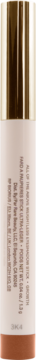Rare B. Weightless Eyeshadow Stick Adventure, cylindryczne opakowanie z beżową etykietą i złotym topem, niewyraźny tekst.