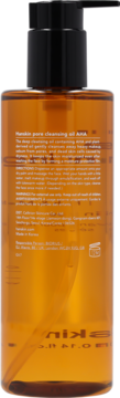 Tył brązowej butelki Hanskin Pore Cleansing Oil AHA z czarną pompką, widoczne białe napisy.