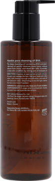 Tył brązowej butelki Hanskin Pore Cleansing Oil BHA oczyszczającego pory, z czarną pompką i białymi napisami.