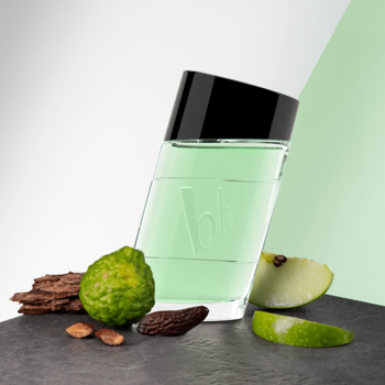 Woda toaletowa bruno banani Made for Men 100ml, butelka pod kątem, z jabłkiem i bergamotką na ciemnym blacie.