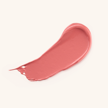 Kremowy swatch różu w sztyfcie Cheek Flirt. Jasny, matowy, brzoskwiniowo-różowy kolor na beżowym tle.