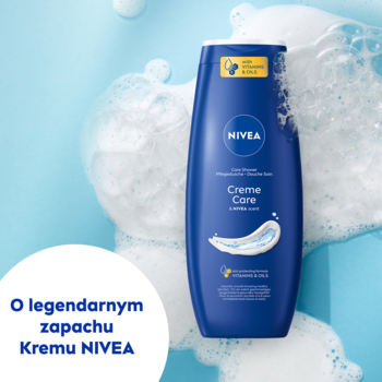 Ciemnoniebieska butelka żelu NIVEA Creme Care z olejkiem i prowitaminą B5, widok z przodu, otoczona pianą.