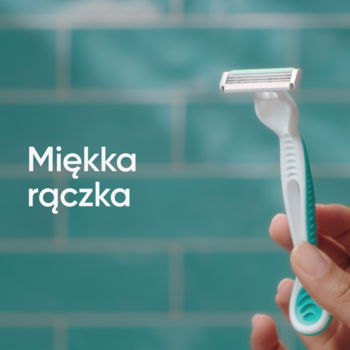 Gillette Venus 3 Sensitive, biało-turkusowa maszynka z napisem "Miękka rączka", w dłoni, na tle turkusowych kafelków.