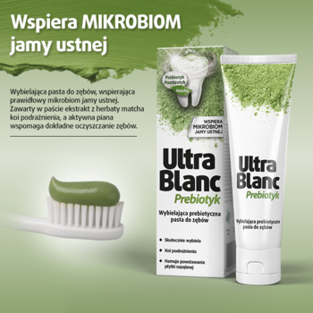 UltraBlanc Prebiotyk wybielająca pasta do zębów. Biała tubka i zielona pasta na szczoteczce, na zielonym tle.