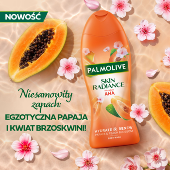 Pomarańczowy żel Palmolive Skin Radiance AHA, papaja i kwiat brzoskwini. Butelka z owocami i różowymi kwiatami.