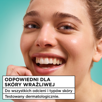 Zbliżenie uśmiechniętej kobiety z promienną cerą, reklamujące krem Garnier Salicylic Fresh & Matte. Napis: odpowiedni dla skóry wrażliwej.