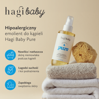 Hagi Baby Pure hipoalergiczny emolient do kąpieli dla niemowląt, butelka z atomizerem, na stosie ręczników.