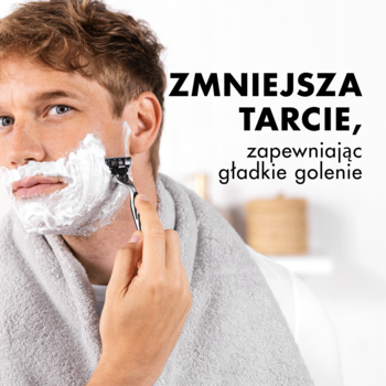 Pianka do golenia Gillette Original: mężczyzna z białą pianką na twarzy, golący się maszynką. Widoczny napis 'ZMNIEJSZA TARCIE'.