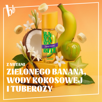 Mgiełka Banana Bite z zielonym bananem i kokosem, butelka wśród owoców na pomarańczowym tle.