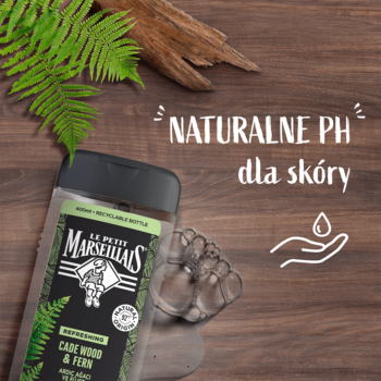 Le Petit Marseillais żel Cade Wood & Fern, ciemna butelka z tekstem 'Naturalne pH dla skóry', na tle drewna.