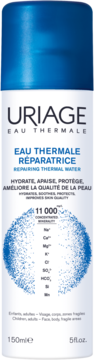 Uriage Eau Thermale, regenerujący spray do twarzy i ciała w białej butelce z niebieskim detalem.