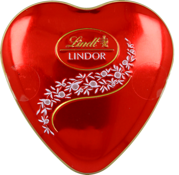 Czerwone metalowe serce Lindt Lindor, opakowanie pralinek z złotym logo i białym kwiatowym wzorem, widok z góry.