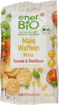 Białe opakowanie enerBiO mini wafli kukurydzianych o smaku pomidorów i bazylii, z logo BIO, otoczone składnikami.