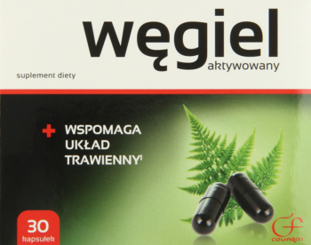 Pudełko suplementu Węgiel aktywowany z 30 kapsułkami, zielone tło, z liśćmi paproci i czarnymi kapsułkami, widok przód.