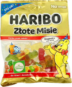 Haribo Złote Misie (Goldbears) w złotym opakowaniu 100-lecia, widok z przodu. Przezroczysty woreczek z kolorowymi żelkami.