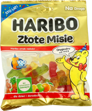 Haribo Złote Misie (Goldbears) w złotym opakowaniu 100-lecia, widok z przodu. Przezroczysty woreczek z kolorowymi żelkami.
