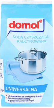 Domol Soda czyszcząca kalcynowana, niebieskie opakowanie 500g z garnkiem i ścierką, widok z przodu.