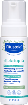 Mustela Stelatopia szampon w piance 150ml, biała butelka z pompką do skóry atopowej, z zielonymi liśćmi, widok z przodu.