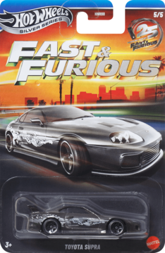 Hot Wheels Fast & Furious Toyota Supra model, silver, in blister pack. Black card with city sunset theme.