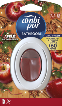 Ambi Pur Bathroom Winter Edition, odświeżacz powietrza Apple & Cinnamon w srebrnym blistrze, na tle jabłek i cynamonu.