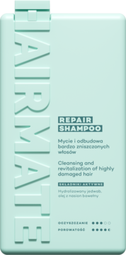 Miętowa butelka szamponu Hairmate Repair do włosów zniszczonych, z przodu widoczny wytłoczony napis HAIRMATE i składniki aktywne.