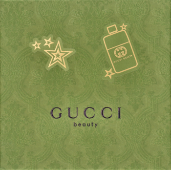 Zielona grafika Gucci Beauty z fioletowym logo, ikoną butelki perfum i trzema świecącymi gwiazdami.