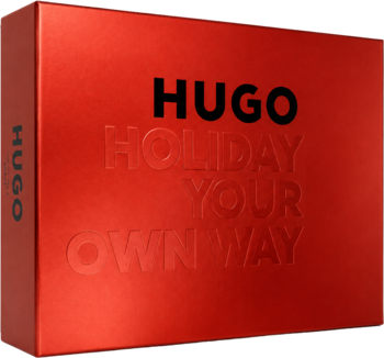 Czerwone pudełko prezentowe HUGO Man z czarnym logo i wytłoczonym hasłem Holiday Your Own Way, widok z góry pod kątem.