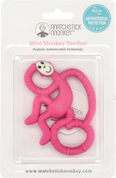 Różowy gryzak Matchstick Monkey w kształcie małpki, silikonowy, antybakteryjny, w opakowaniu, widok z przodu.