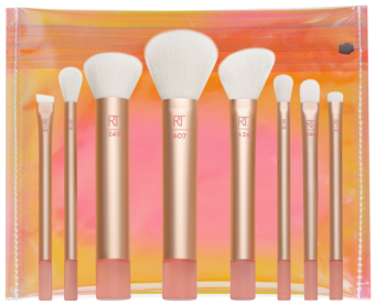 Zestaw 8 podróżnych pędzli Real Techniques The Wanderer z białym włosiem i rose gold rączkami, w przezroczystej kosmetyczce.