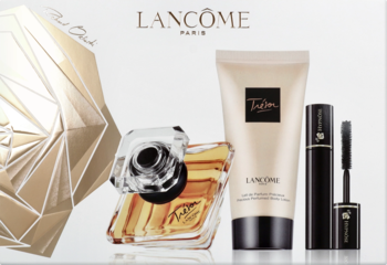 Zestaw Lancôme Trésor: złote perfumy w butelce, beżowy balsam do ciała i czarny tusz, na tle białego pudełka.